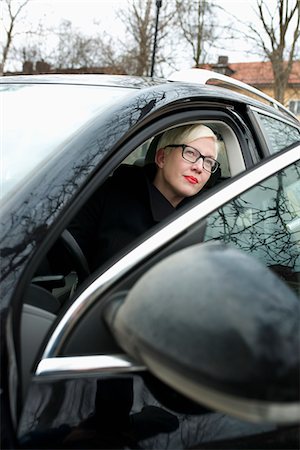 side mirror - Sweden, Sodermanland, Stockholm, Blonde woman on driver's seat in black car Stock Photo - Premium Royalty-Free, Code: 6126-08781124