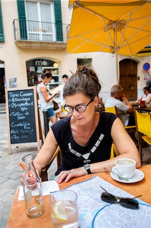 simsearch:824-02888188,k - Spain, Mallorca, Las Palmas, Mature woman writing at table in restaurant Stock Photo - Premium Royalty-Free, Code: 6126-08781133