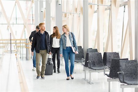 simsearch:6102-03905884,k - Sweden, Vasterbotten, Umea, Men and women walking with suitcases and talking Stock Photo - Premium Royalty-Free, Code: 6126-08781224