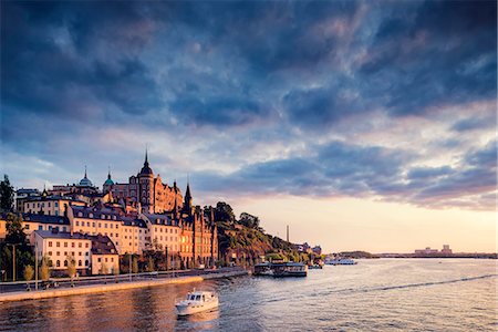 Sweden, Stockholm, Sodermalm, Sodermalarstrand, Waterfront at sunset Stock Photo - Premium Royalty-Free, Code: 6126-08781490
