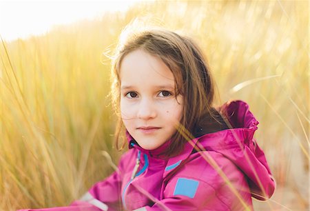 preadolescence clothing - Sweden, Blekinge, Portrait of girl (10-11) sitting in tall grass Stock Photo - Premium Royalty-Free, Code: 6126-08781403