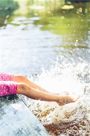 swedish - Sweden, Low section of girl (8-9) splashing water with legs Stock Photo - Premium Royalty-Free, Code: 6126-08781420