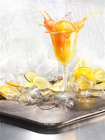 drinks, nobody - Studio shot of orange cocktail on silver tray Stock Photo - Premium Royalty-Free, Code: 6126-09102492