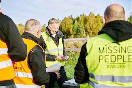 problem smile - Volunteers helping emergency services find missing people Stock Photo - Premium Royalty-Free, Code: 6126-09102423