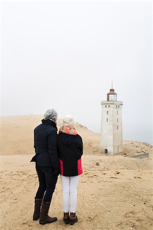 Mother and daughter looking at Rubjerg Knude fyr lighthouse Stock Photo - Premium Royalty-Free, Code: 6126-09102606