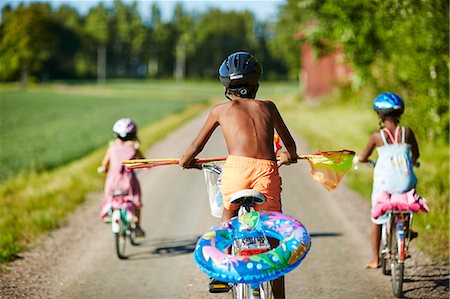Children cycling on a rural road in Gullspang, Sweden Stock Photo - Premium Royalty-Free, Code: 6126-09102957