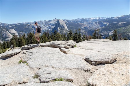 Boy during mountain trip, Sentinel Dome and Yosemite Falls in background Stock Photo - Premium Royalty-Free, Code: 6126-09102970