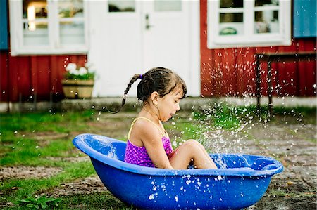 Girl in paddling pool Stock Photo - Premium Royalty-Free, Code: 6126-09103052