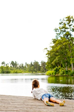 simsearch:6126-09103917,k - Girl lying on pier beside lake in Friseboda, Sweden Foto de stock - Sin royalties Premium, Código: 6126-09103038