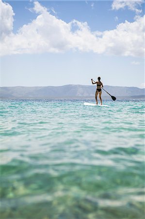 A woman paddle boarding in Croatia Stock Photo - Premium Royalty-Free, Code: 6126-09103180