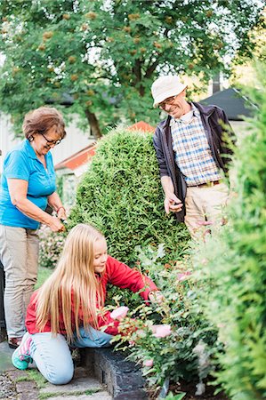 person helping elderly woman - Grandparents and granddaughter working in garden Stock Photo - Premium Royalty-Free, Code: 6126-09103103