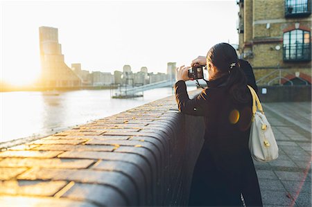 Mid adult woman taking pictures at riverbank in Rotherhithe Foto de stock - Sin royalties Premium, Código: 6126-09103650