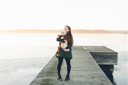 simsearch:6102-07769279,k - Young woman on pier with her dog during winter in Blekinge, Sweden Stock Photo - Premium Royalty-Free, Code: 6126-09103687