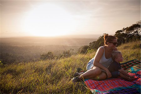 Mother and son sitting in a field in Kenya Stock Photo - Premium Royalty-Free, Code: 6126-09103886