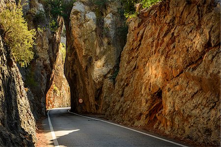 european street sign - Empty road between tall rocks at Mallorca Stock Photo - Premium Royalty-Free, Code: 6126-09104032