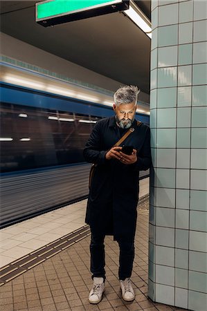 simsearch:6126-09267293,k - Man texting at train station in Stockholm, Sweden Stock Photo - Premium Royalty-Free, Code: 6126-09104380