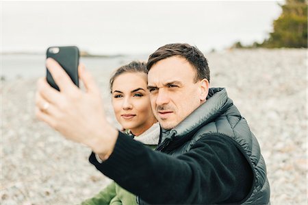 simsearch:6126-09103925,k - Young couple taking selfie at beach in Sodermanland, Sweden Stock Photo - Premium Royalty-Free, Code: 6126-09104388