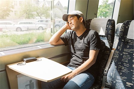 simsearch:6126-09104291,k - Man sleeping on train Foto de stock - Sin royalties Premium, Código: 6126-09104335