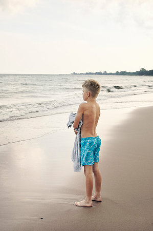 simsearch:6126-09267387,k - Boy carrying towel on beach Photographie de stock - Premium Libres de Droits, Code: 6126-09267395
