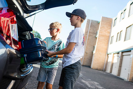 family loading car - Boys unloading suitcase from car boot Stock Photo - Premium Royalty-Free, Code: 6126-09267599