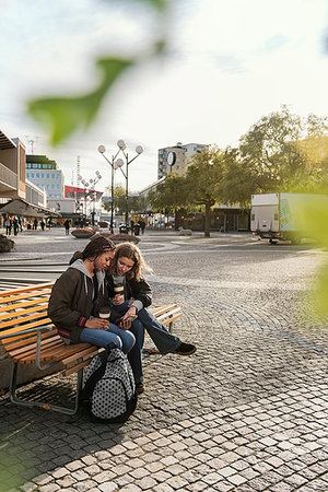 simsearch:6126-09103925,k - Teenage girls using smart phone on bench Stock Photo - Premium Royalty-Free, Code: 6126-09267750