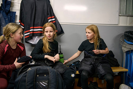 Girls in changing room prepare for ice hockey training Stock Photo - Premium Royalty-Free, Code: 6126-09268065