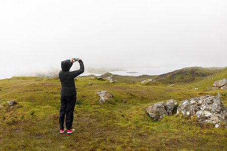 Woman taking photograph of Old Man of Storr through fog on Isle of Skye, Scotland Foto de stock - Sin royalties Premium, Código: 6126-09204296