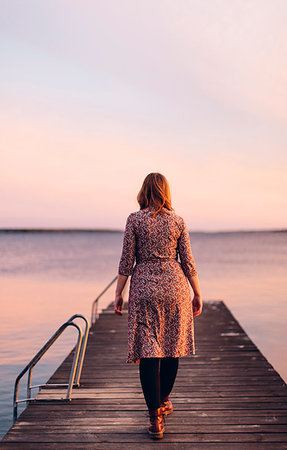 spring (body of water) - Rear view of woman on pier at beach in Blekinge, Sweden Stock Photo - Premium Royalty-Free, Code: 6126-09204593