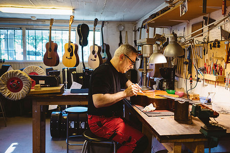 Craftsman working in guitar making workshop Stock Photo - Premium Royalty-Free, Code: 6126-09204872