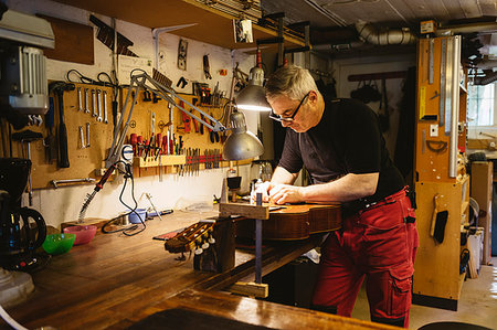 Craftsman working in guitar making workshop Stock Photo - Premium Royalty-Free, Code: 6126-09204874