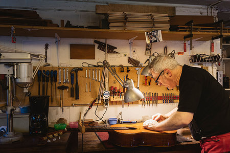Craftsman working in guitar making workshop Stock Photo - Premium Royalty-Free, Code: 6126-09204875
