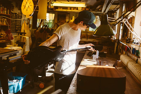 Craftsman working in guitar making workshop Stock Photo - Premium Royalty-Free, Code: 6126-09204876