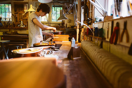 Craftsman working in guitar making workshop Stock Photo - Premium Royalty-Free, Code: 6126-09204878