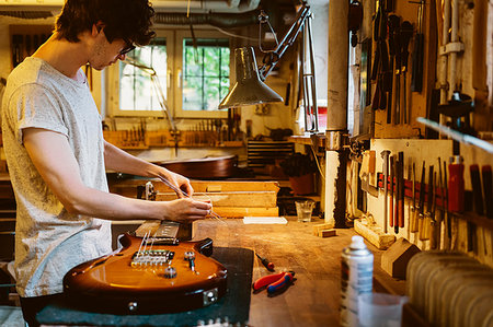 Craftsman working in guitar making workshop Stock Photo - Premium Royalty-Free, Code: 6126-09204880