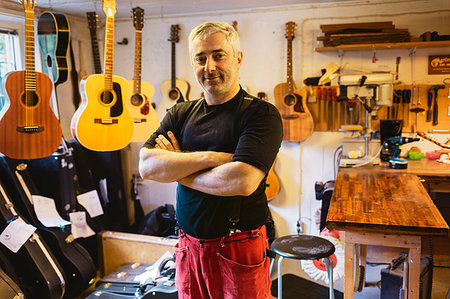 Portrait of craftsman in guitar making workshop Stock Photo - Premium Royalty-Free, Code: 6126-09204885