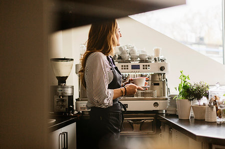 simsearch:6126-09104476,k - Barista holding coffee in cafe kitchen Stock Photo - Premium Royalty-Free, Code: 6126-09204817