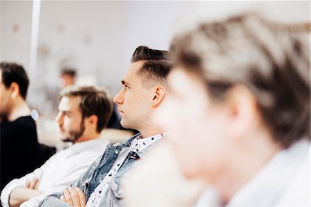 Male students looking away while sitting in media class Stock Photo - Premium Royalty-Free, Code: 6127-08666643