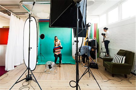 Fashion models getting dressed while assistants working in studio Stock Photo - Premium Royalty-Free, Code: 6127-08667286