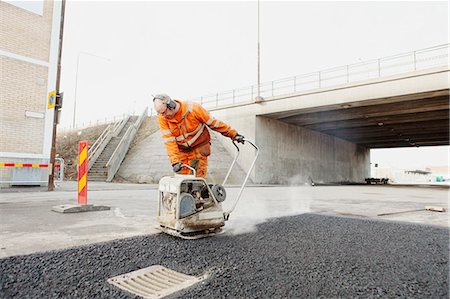 Mature manual worker laying asphalt at road construction site Stockbilder - Premium RF Lizenzfrei, Bildnummer: 6127-08667528