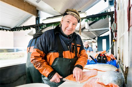 fillet - Happy mature fisherman filleting salmon in fishing industry Stock Photo - Premium Royalty-Free, Code: 6127-08688871
