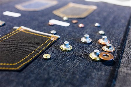 Buttons on denim fabric in factory Stock Photo - Premium Royalty-Free, Code: 6127-08689200