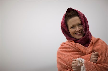 photos of ominous sea storms - Portrait of a smiling woman wrapped in blankets. Stock Photo - Premium Royalty-Free, Code: 6128-08747559