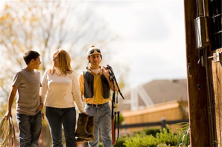 father teen farm - Parents and son carrying riding gear Stock Photo - Premium Royalty-Free, Code: 6128-08747603