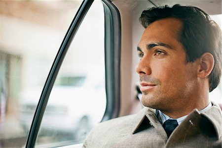 simsearch:695-05772524,k - Thoughtful businessman looks out of a taxi window. Foto de stock - Royalty Free Premium, Número: 6128-08747610