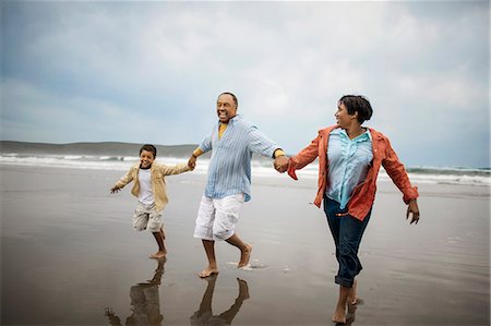 simsearch:6128-08825442,k - Family enjoying day at beach. Stock Photo - Premium Royalty-Free, Code: 6128-08747764