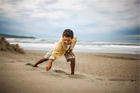 Young boy enjoying day at beach. Stock Photo - Premium Royalty-Free, Code: 6128-08747765