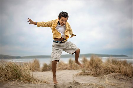 Young boy enjoying day at beach. Stock Photo - Premium Royalty-Free, Code: 6128-08747766