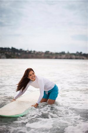 simsearch:6128-08747955,k - Young woman heading into the surf with a surfboard. Stock Photo - Premium Royalty-Free, Code: 6128-08747830