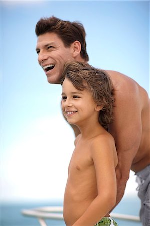 depth of field images - Smiling father and son on the deck of a boat. Stock Photo - Premium Royalty-Free, Code: 6128-08747999