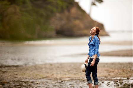 Happy teenage girl walking on rocky beach. Stock Photo - Premium Royalty-Free, Code: 6128-08748141